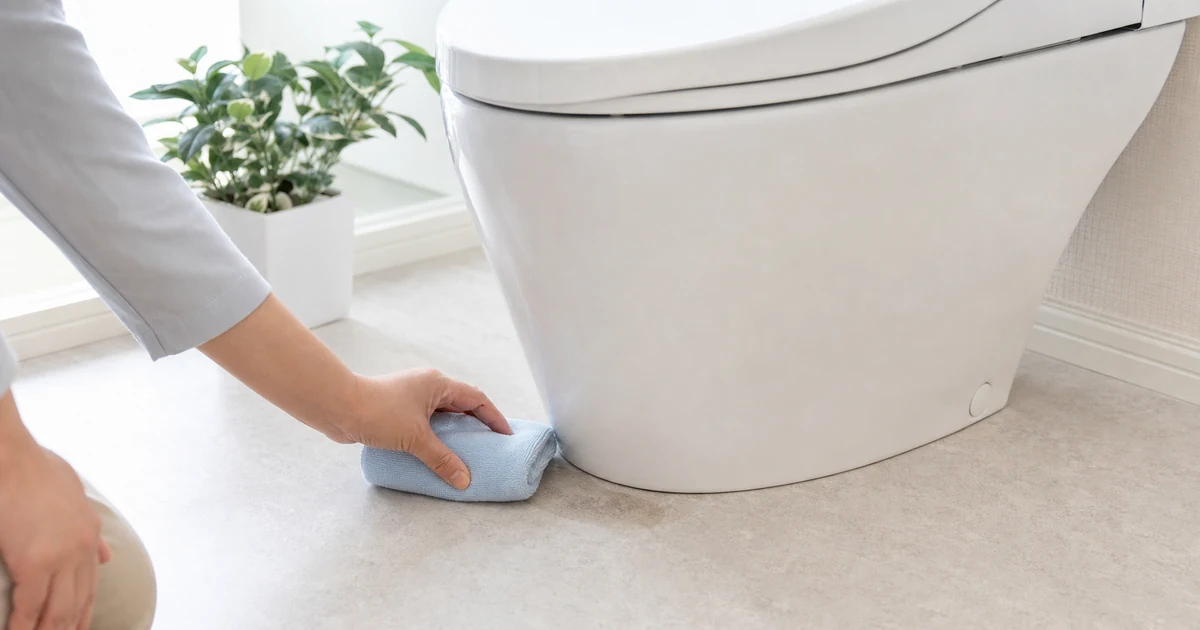 トイレ床の落ちない黒ずみを確認する様子
